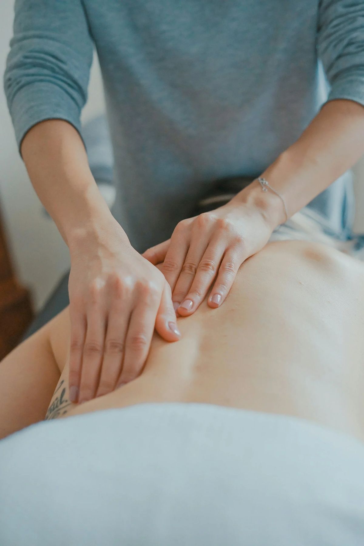 A massage therapist working on a client's back